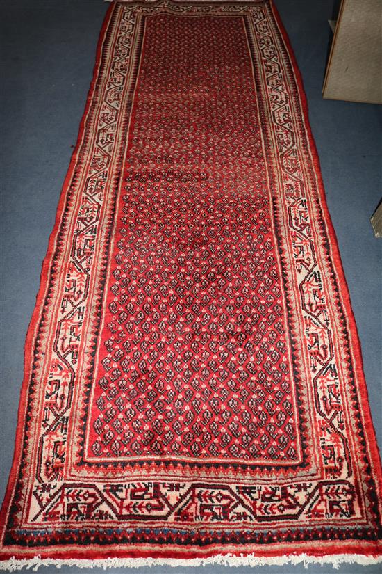 An Araak red ground runner, 10ft 1in by 3ft 7in.